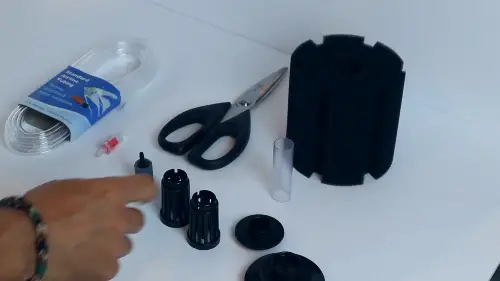 A sponge filter that has been taken apart as step two of a sponge filter setup process 