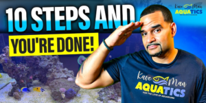 KaveMan Aquatics saluting with a vibrant blue saltwater tank and text